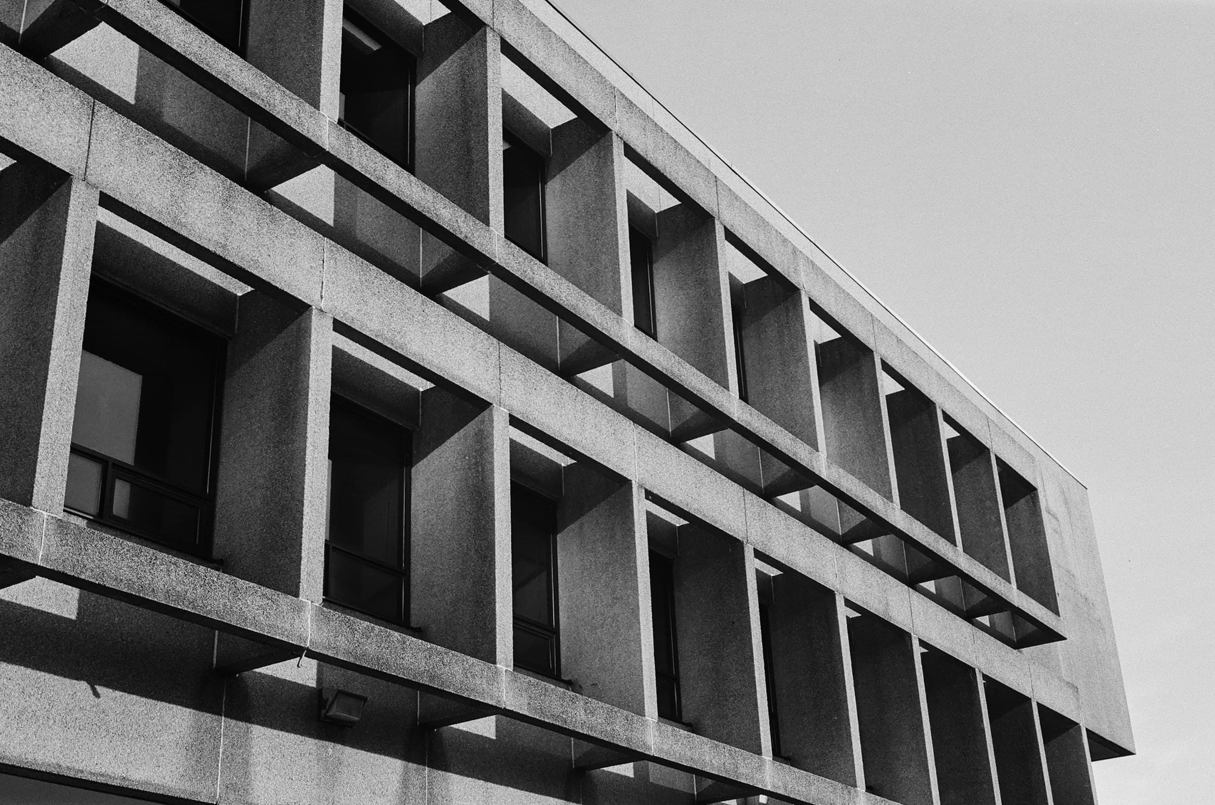 Deep-set concrete facade grid in black and white