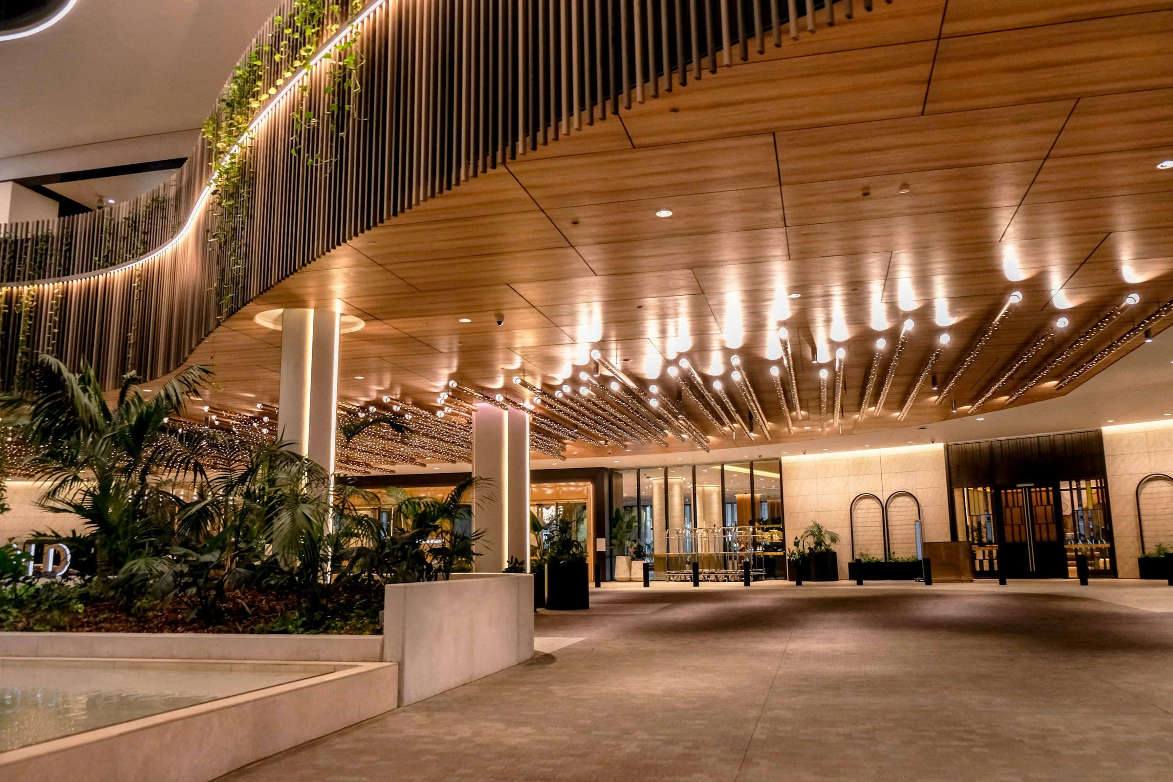 Hotel arrival court beneath a curved timber ceiling