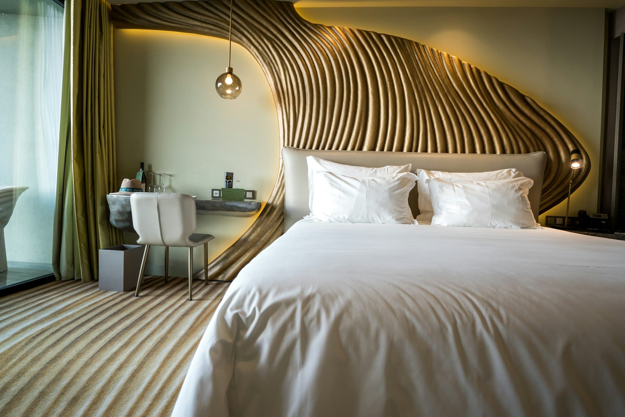Hotel room with a sculpted timber headboard