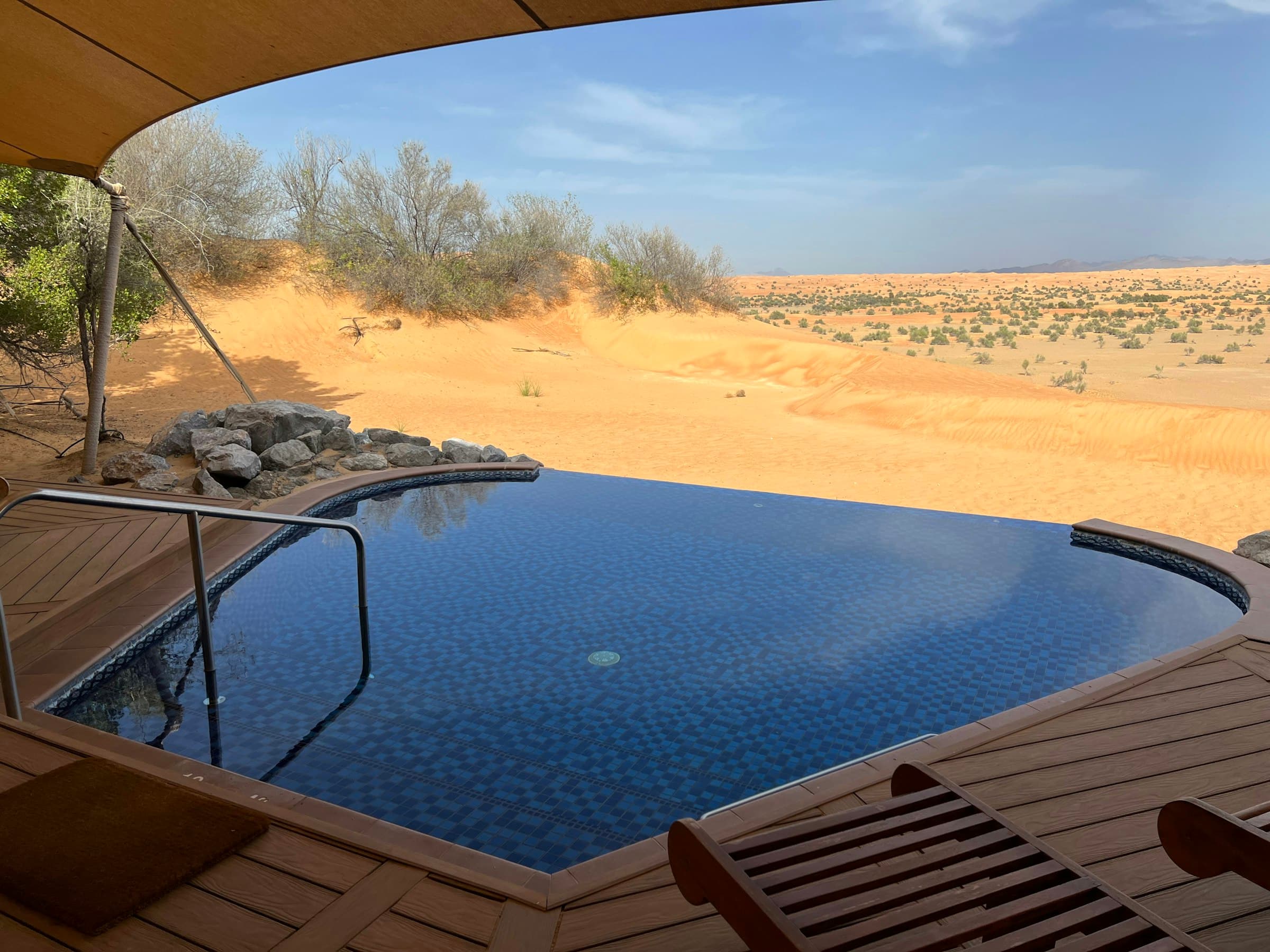 Private plunge pool looking out over desert dunes